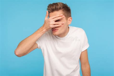 A Curious Man Looking At You Through His Fingers Stock Image Image Of
