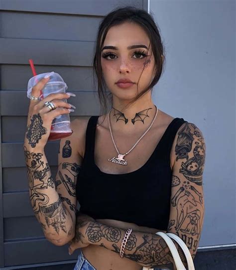 Download A Tattooed Girl Admiring Her Artful Body