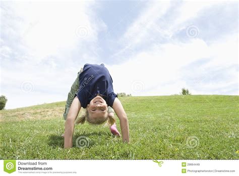Girl Bending Over Backwards On Grass Royalty Free Stock