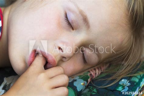 little pretty girl sleeping sucking thumb and having