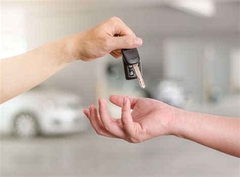 male hand holding  car key  handing     person pro