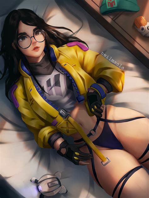 A Woman In Glasses And A Yellow Jacket Laying On Top Of A Bed
