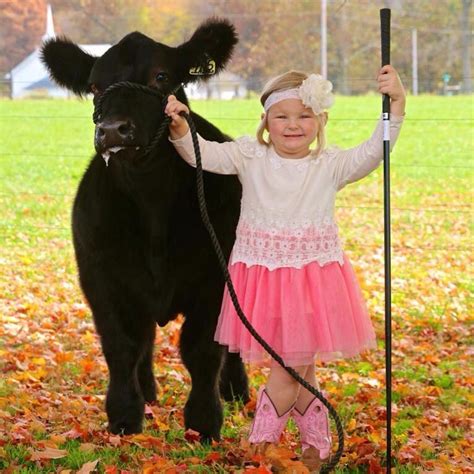 so stinkin cute she is cheesin big time with her calf also love the head to toe pink it s