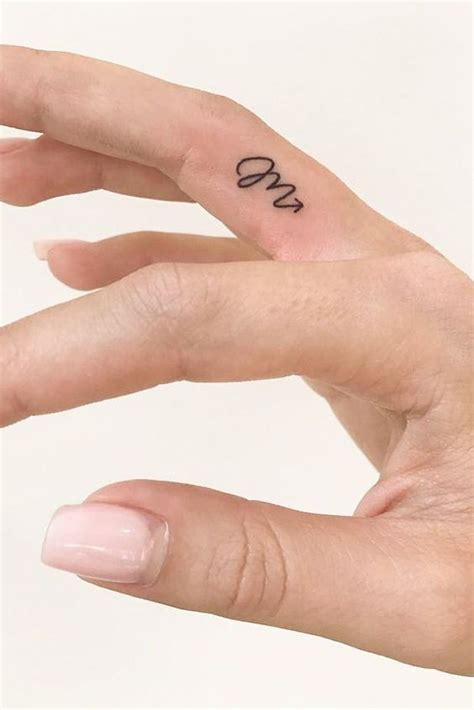 scorpio zodiac symbol tattooed on the finger otziapp