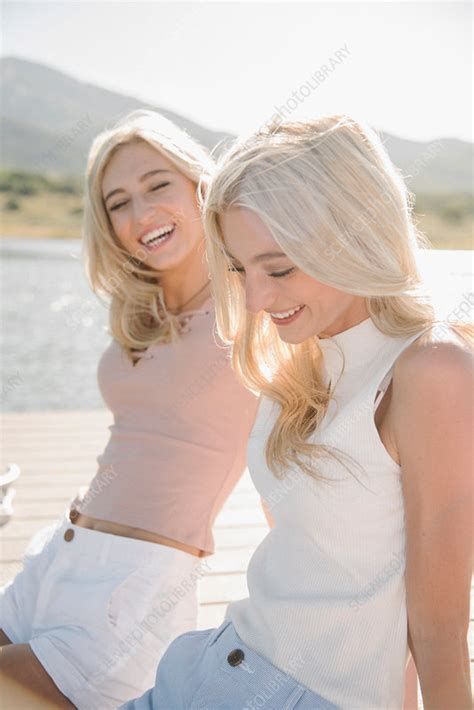 portrait of two blond sisters on a jetty stock image f017 7508