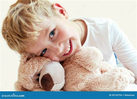 cute  boy hugs  teddy bear stock photo image