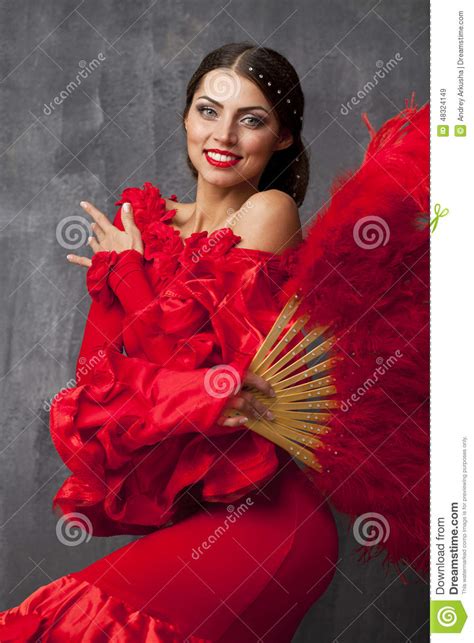 woman traditional spanish flamenco dancer dancing in a red dress
