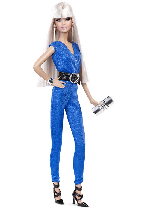 a barbie doll with blonde hair and blue jumpsuits holding a silver