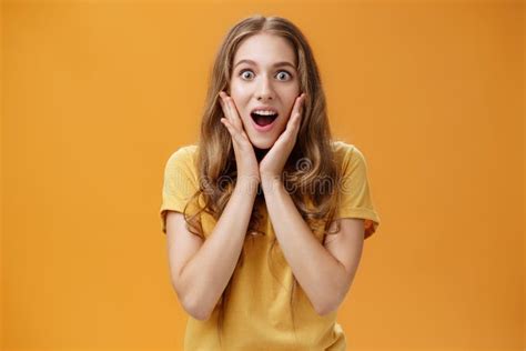 waist up shot of surprised and amused girl learning shocking awesome