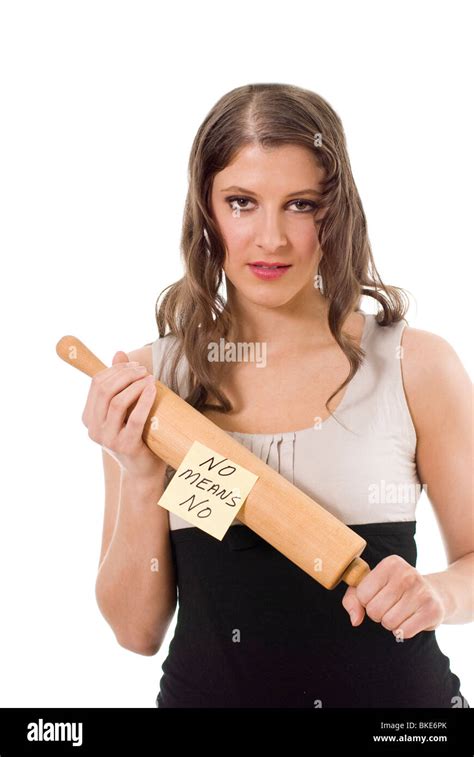 Young Woman With A Threatening Look Holding A Rolling Pin With The