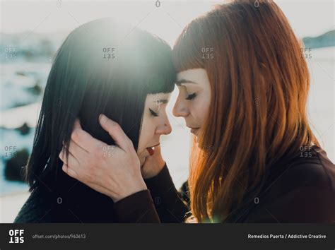 Side View Of Modern Sensual Lesbian Couple In Love Embracing While