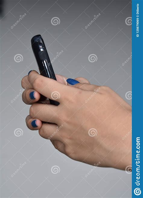 female teen hand holding cell phone texting stock image