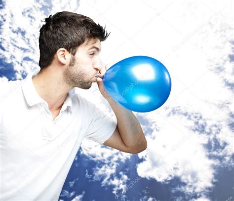 man blowing balloon stock photo  coolfonk