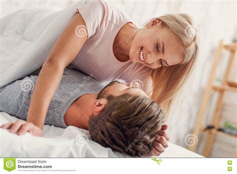 Cute Loving Couple Luxuriating In Bedroom Stock Image