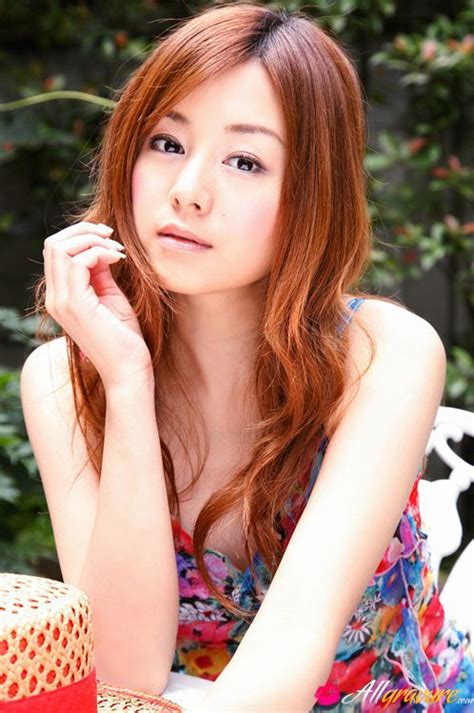 red headed asian cutie posing in a floral printed dress