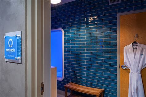 blue tiled bathroom   robe hanging   door   wooden