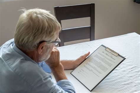 senior  man elderly examining  checking    testament