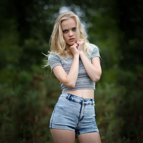 bautiful blond teenage girl alone in the woods stock image