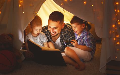 happy family father  children reading  book  tent  home