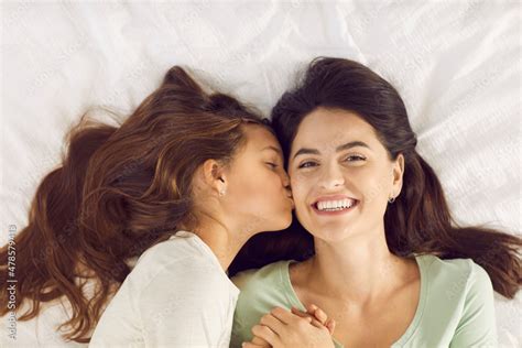 time to get up daughter wakes up mum with kiss on morning of mother s