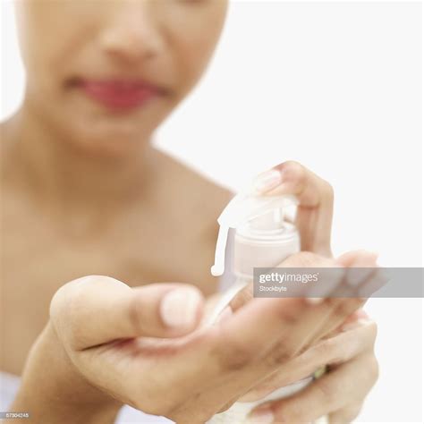 Closeup Of A Young Woman Squirting Lotion Into Her Hand Photo Getty