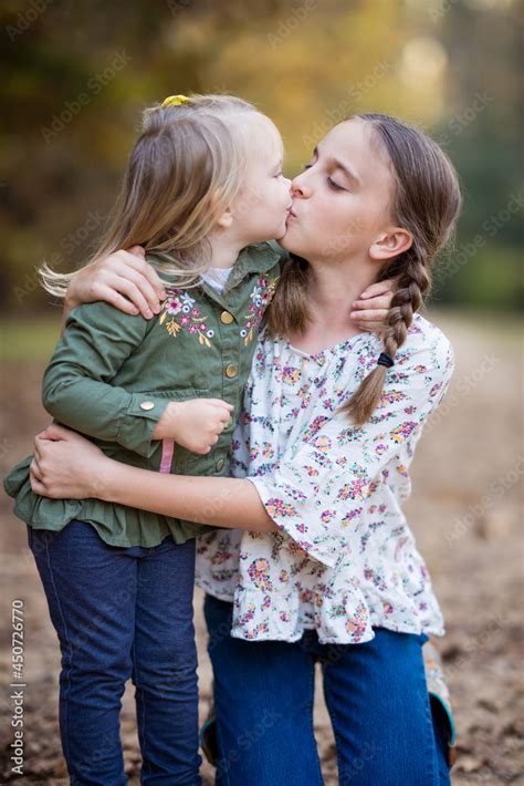 portrait   sisters kissing stock photo adobe stock