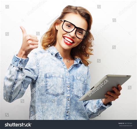 happy teenage girl wearing glasses with tablet pc computer