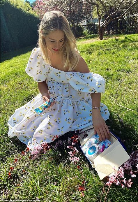 phoebe burgess poses in floral off the shoulder dress as she relaxes at