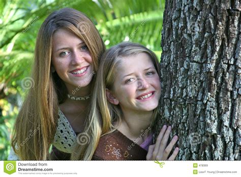 teen sisters by tree royalty free stock images image 478369