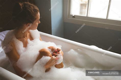 Woman Taking A Bubble Bath In Bathroom At Home — Caucasian Ethnicity