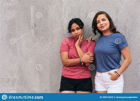 Latin Lesbian Couple Standing On A City Street While Enjoying A Day