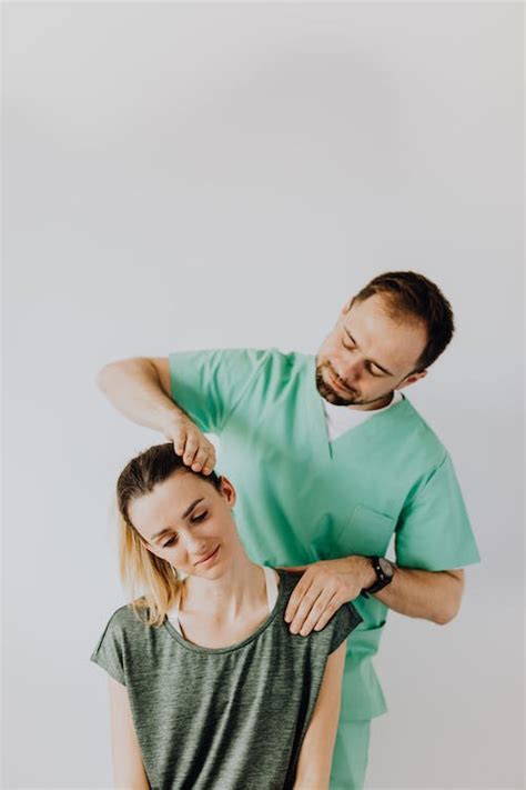 Content Massage Therapist Doing Neck Massage On Female Patient · Free