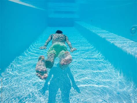 underwater shot  man floating  swimming pool  stocksy contributor urs siedentop
