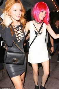 birthday girl bella thorne goes braless in a plunging tie up top and leather mini as she