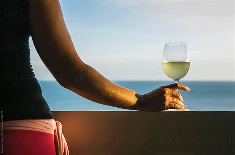 Woman Holding Wine Glass By The Beach By Raymond Forbes Llc Luxury