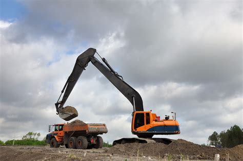 excavator  dump truck stock photo