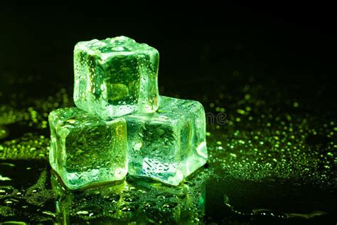 green ice cubes reflection  black table stock photo image  bright