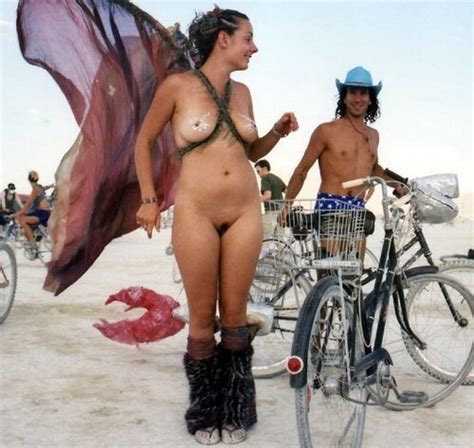 another woman naked with wings at burning man nudeshots