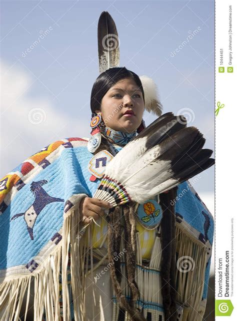A Portrait Of A Native American Woman Holding A Feather