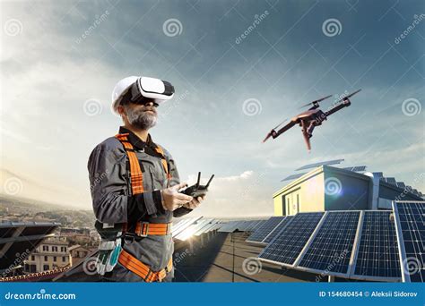 happy engineer  drone  vr helmet  cheking solar station  roof stock photo image