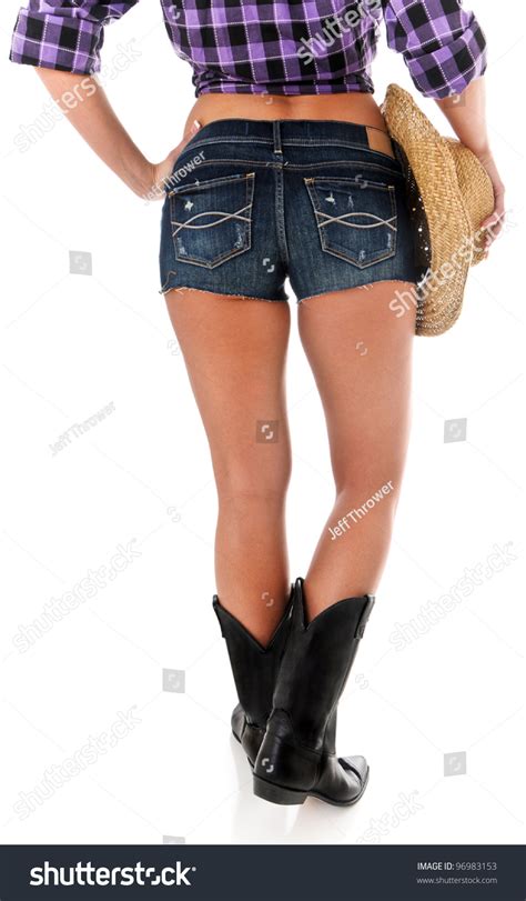 sexy back side of a cowgirl wearing jean shorts plaid