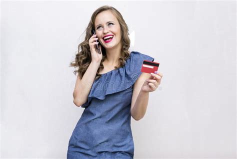 white girl blue dress with curly hair holding a credit card and stock