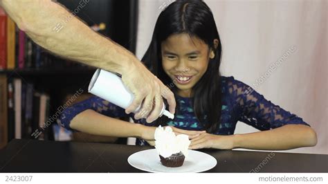 Asian Girl Enjoys Whip Cream On Birthday Cupcake 動画素材 2423007