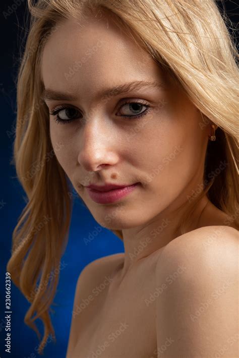 Sad Beautiful Blonde Transgender With Bare Shoulders Looking At Camera