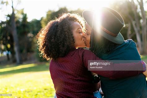 lesbian couple kissing in the park photo getty images