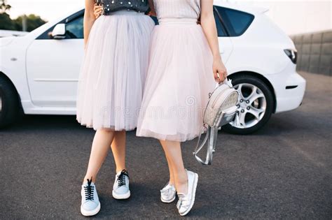 two fashion attractive girls in light tulle skirts having fun on
