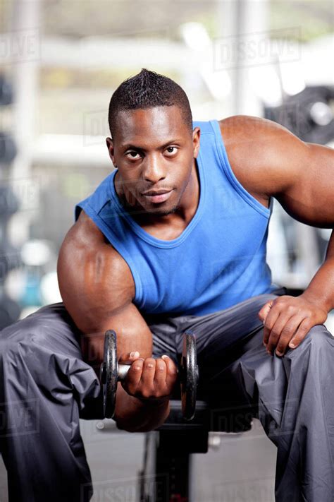 young muscular black man lifting weights   gym stock photo dissolve