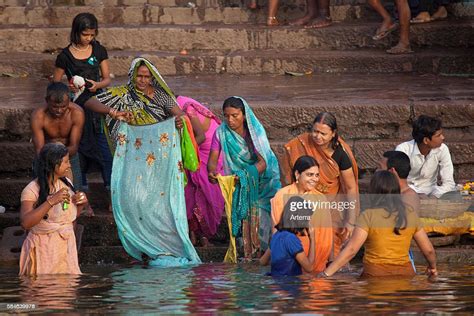 Old Indian Women Bathing In Polluted Water Of The Ganges River At