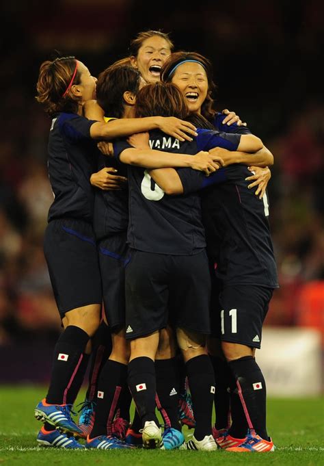 the japanese women s soccer team huddled together during their game