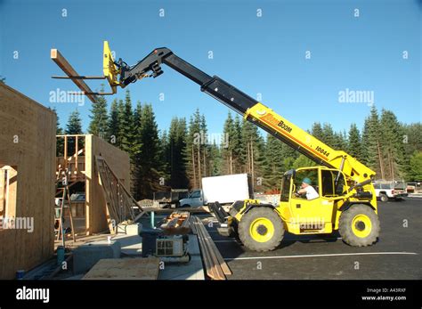 construction operator  highlift crane  forklift moves wood